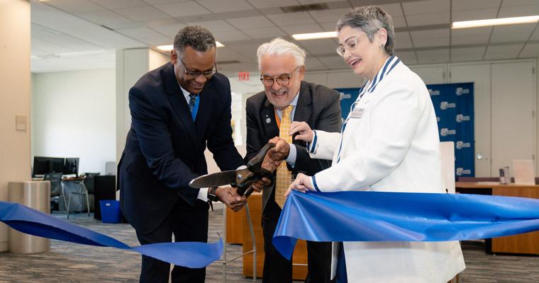 Vice Chancellor for Student Affairs Karen Ferrer-Muñiz, Chancellor Marcelo Suárez-Orozco, and Assistant Vice Chancellor Steven Neville cut t 